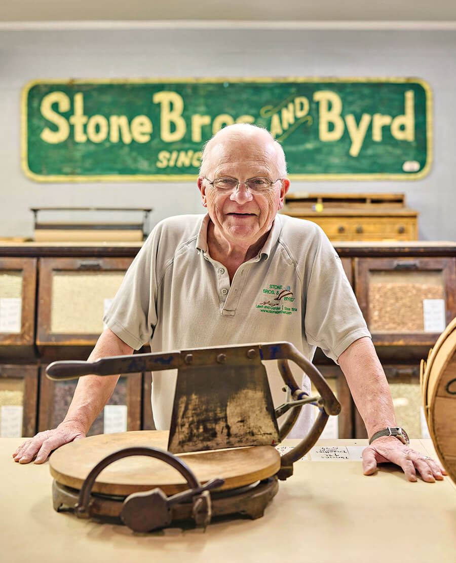 George Davis displays the original slicer used to cut hoop cheese
