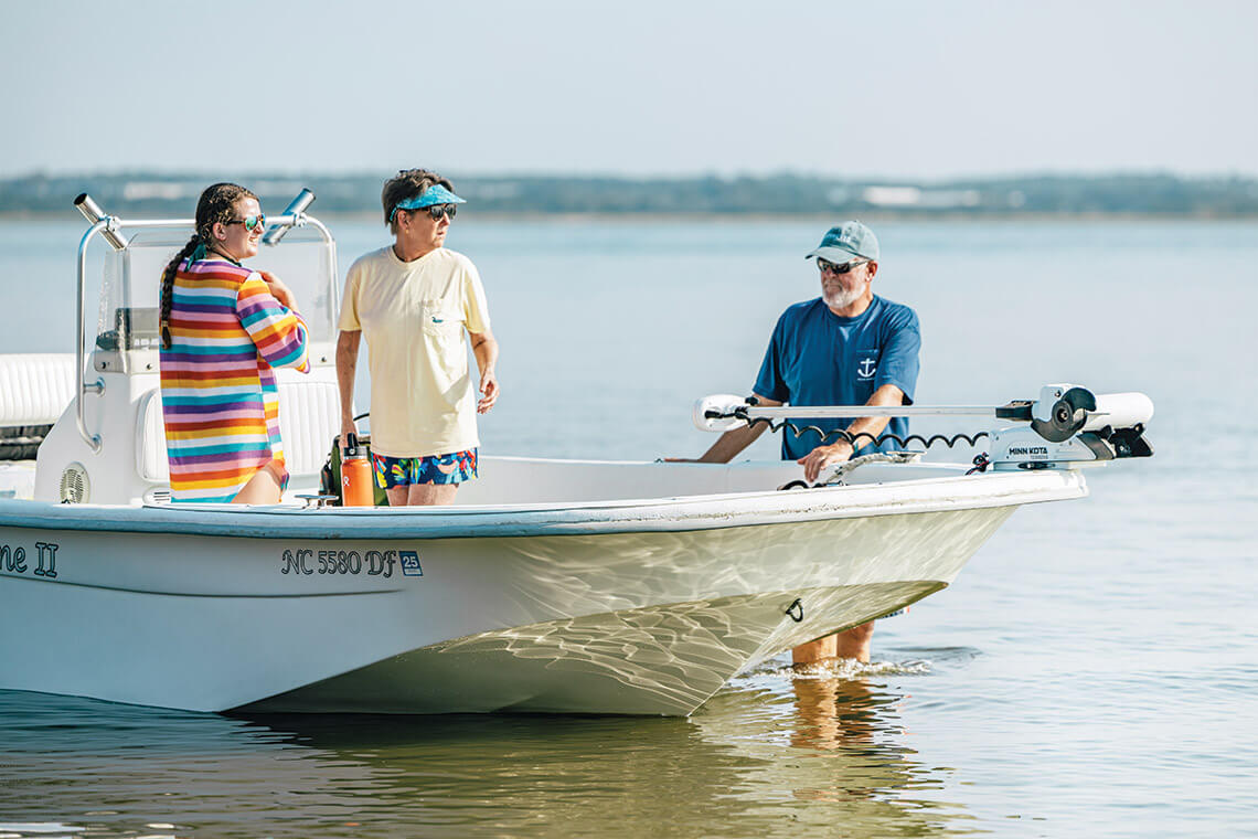 Chris, Kathy, and Caroline Yeomans on a boat heading to Diamond City, NC