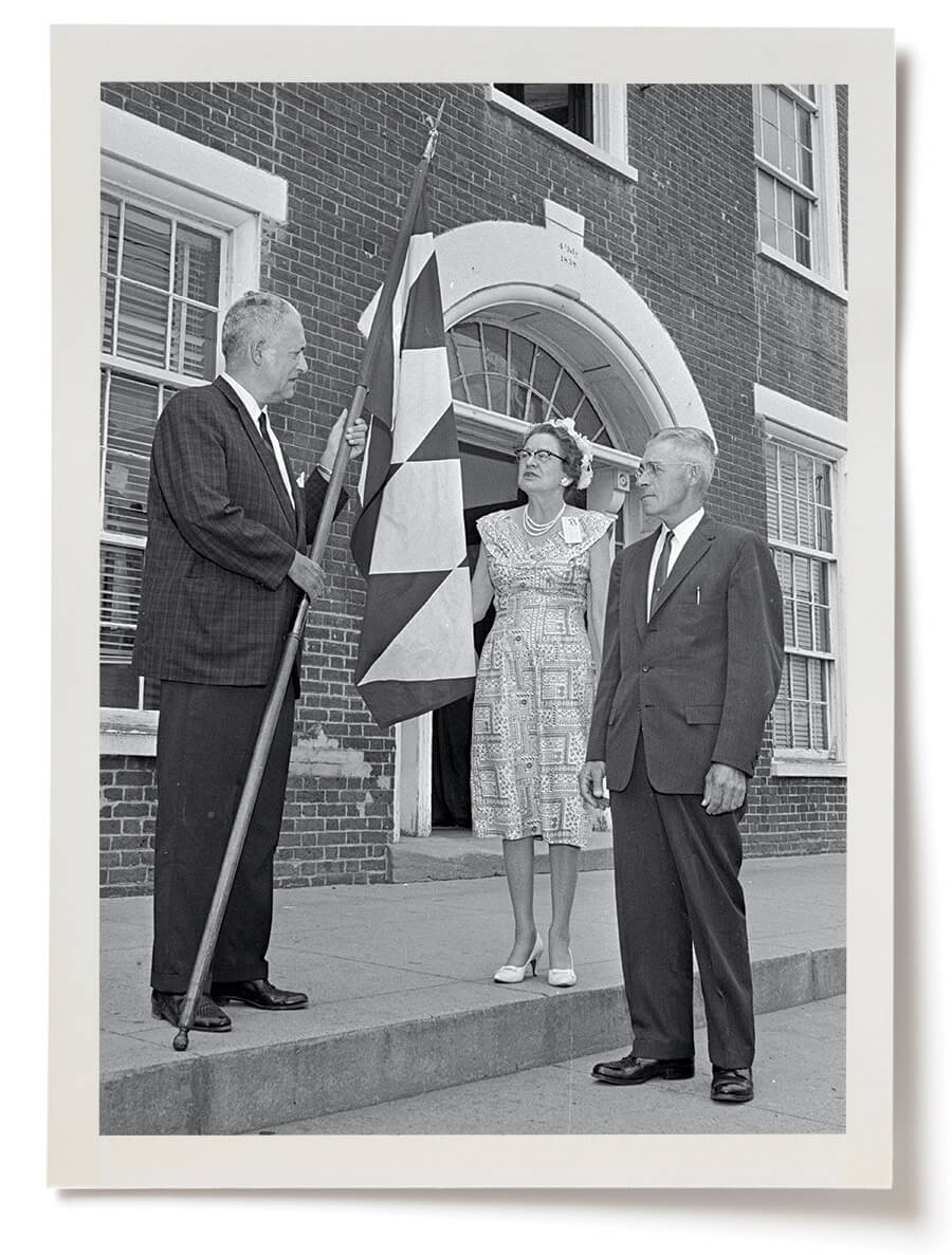 Black and white photo of Capt. Alfred L. Nicholson of the British Consulate in Norfolk, Virginia, visited Granville County and presented Elizabeth Hicks Hummel and T. Watkins Carrington with a replica of the Earl of Granville’s flag.