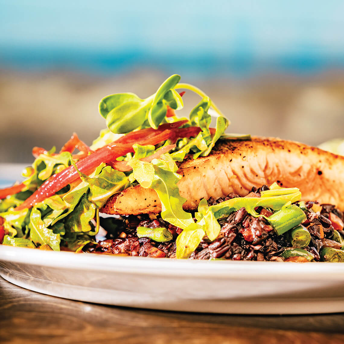 Salmon with Italian black rice risotto and seasonal vegetables