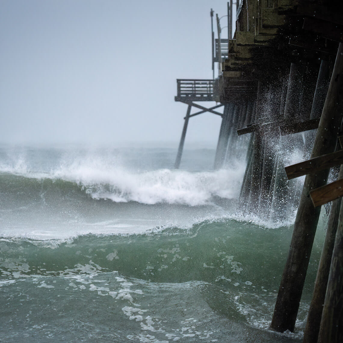 Ocean waves against pier pilings in a storm