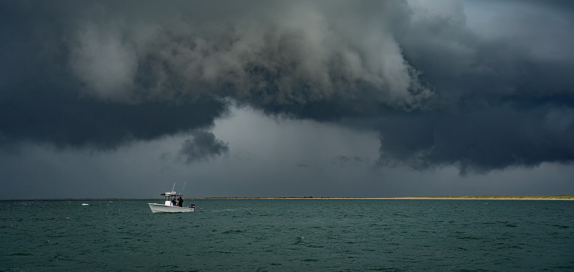 Boat on the ocean as a summer storm rolls in