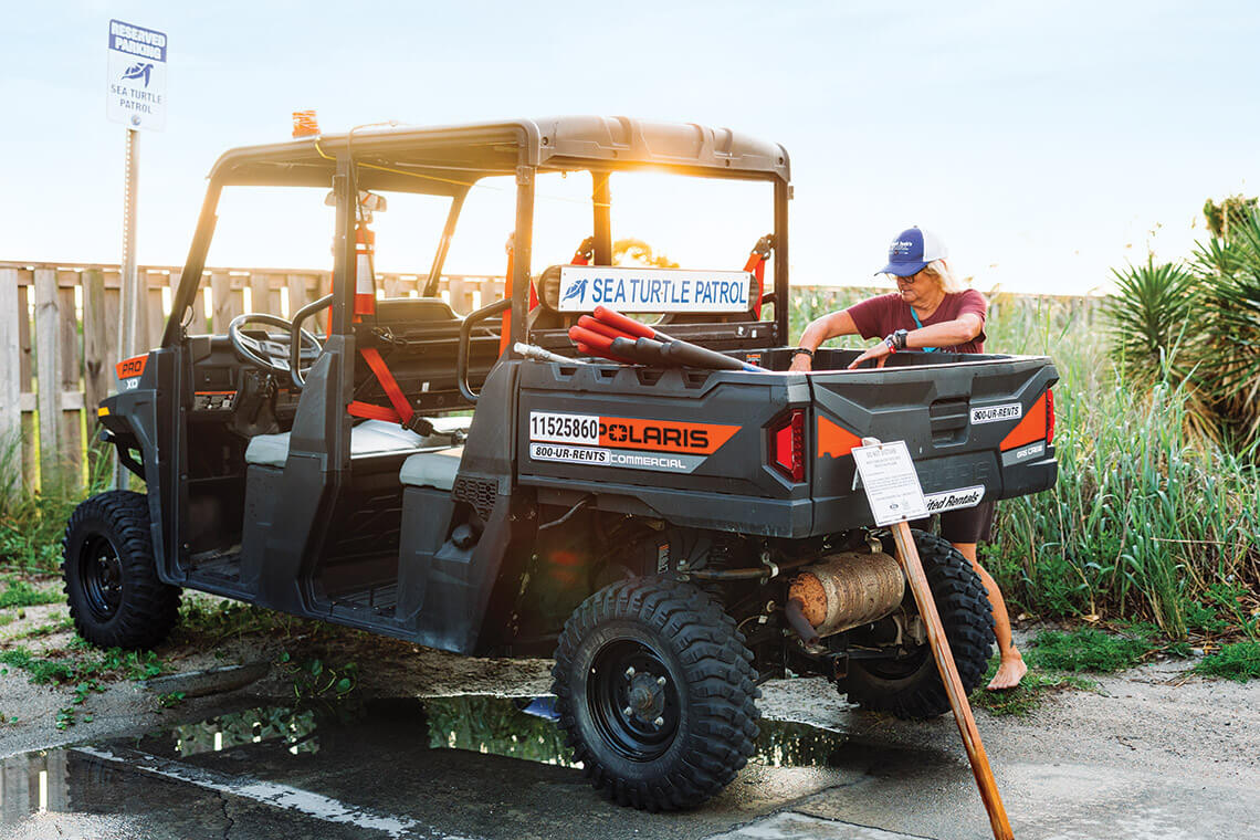 Busovne loads up the Sea Turtle Patrol Polaris vehicle before heading out on patrol