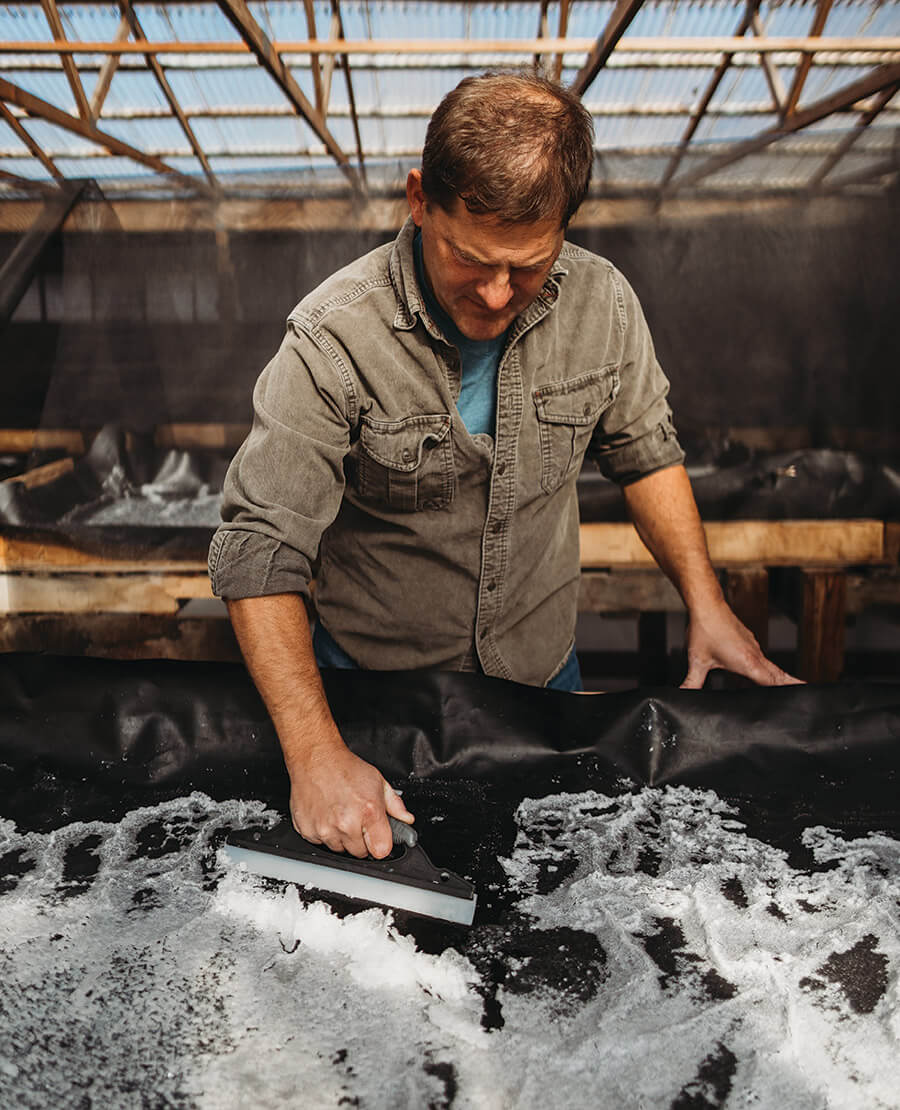 Jason Zombron scrapes salt crystals for Sea Love Sea Salt Co.