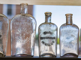 Glass bottles on a shelf at Country Boy Antiques