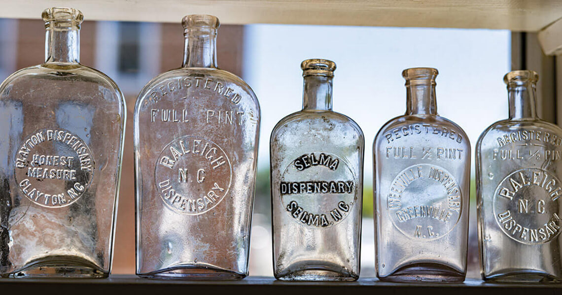Glass bottles on a shelf at Country Boy Antiques