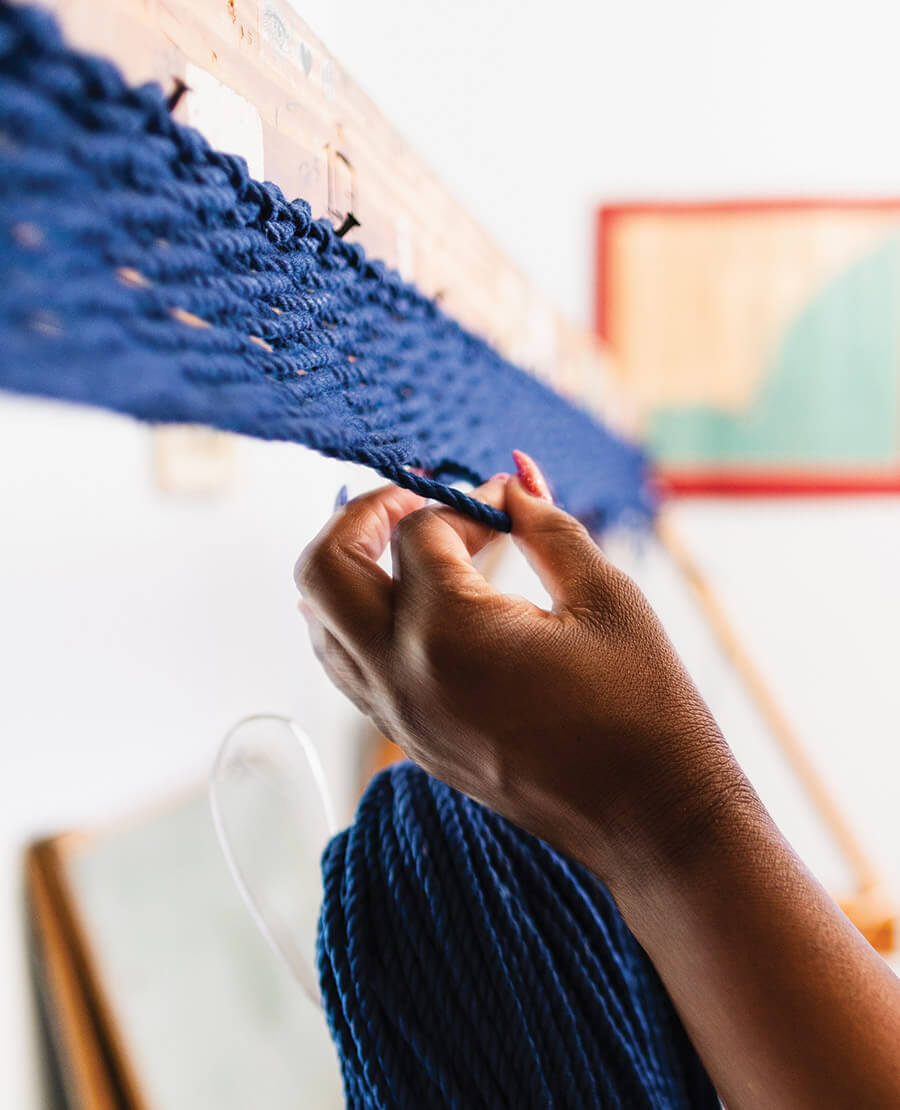 Jasmine Beck weaving a hammock