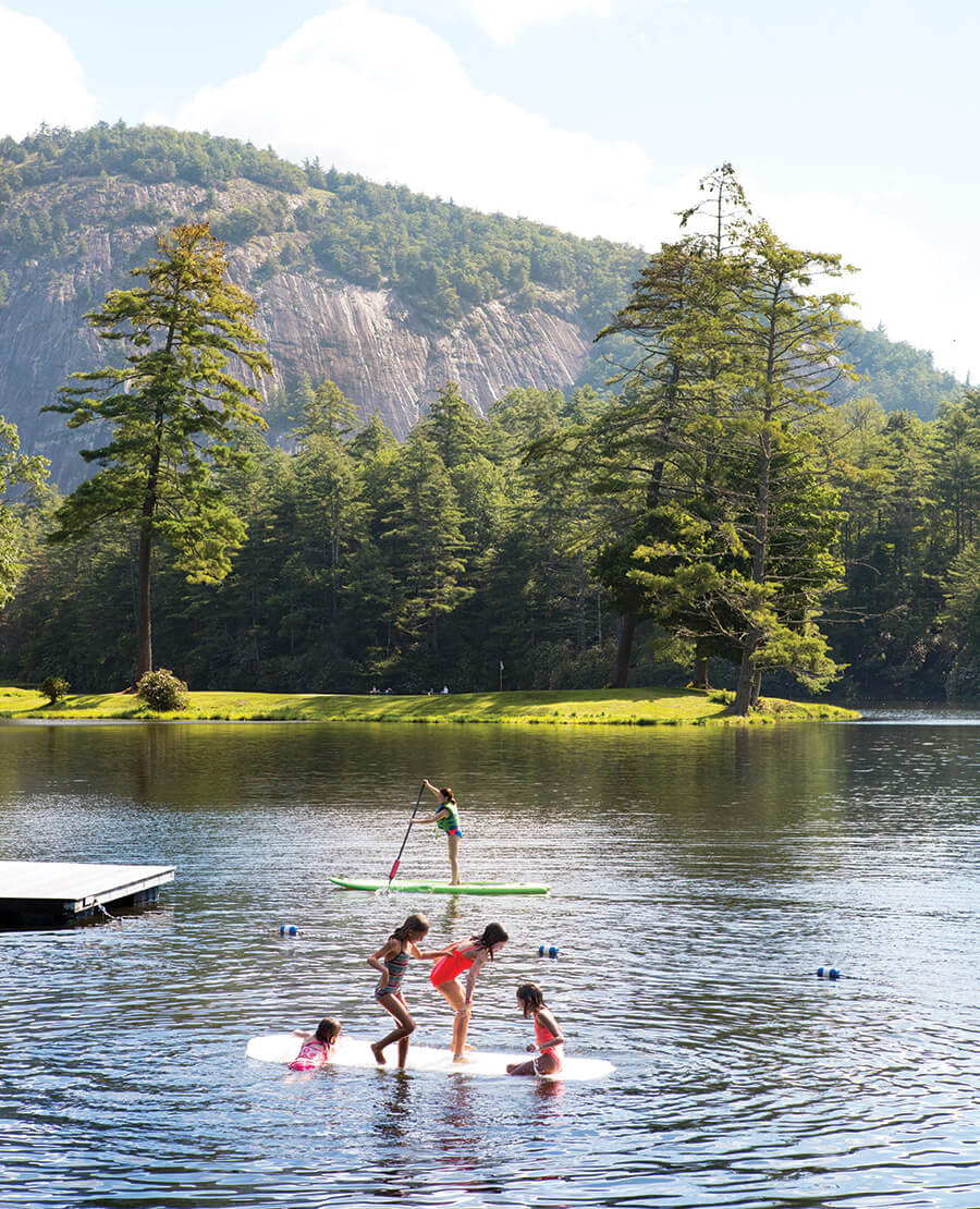 Children paddleboard and play on the lake at High Hampton Resort