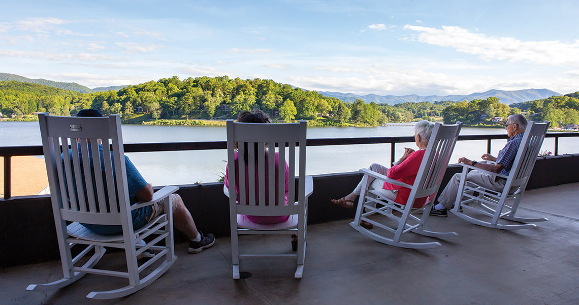 People in rocking chairs at Lake Junaluska