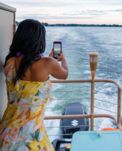 Woman takes a photo on a boat