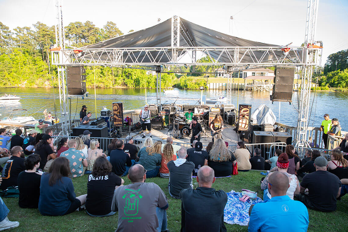 Crowd watches performance at The Landing at the Boathouse