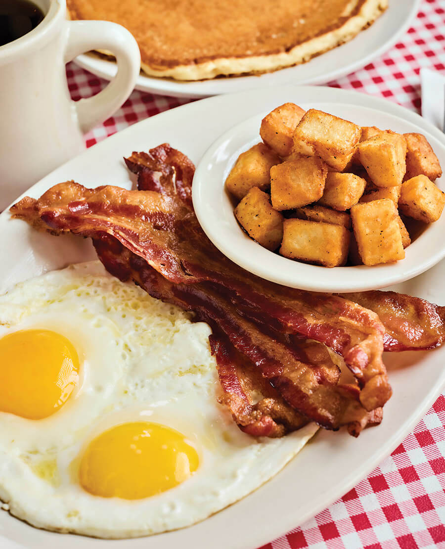 Plate of eggs, bacon, and potatoes at Barry's