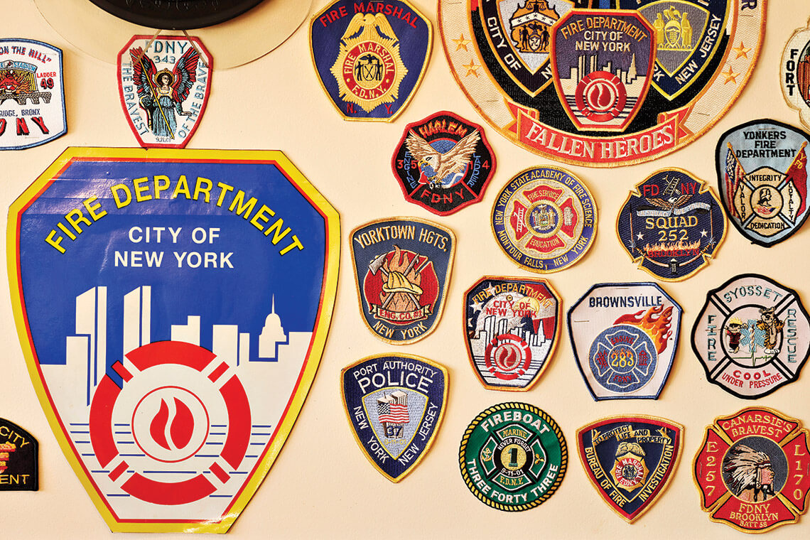 Fire and police department badges on the wall at Barry's Cafe.