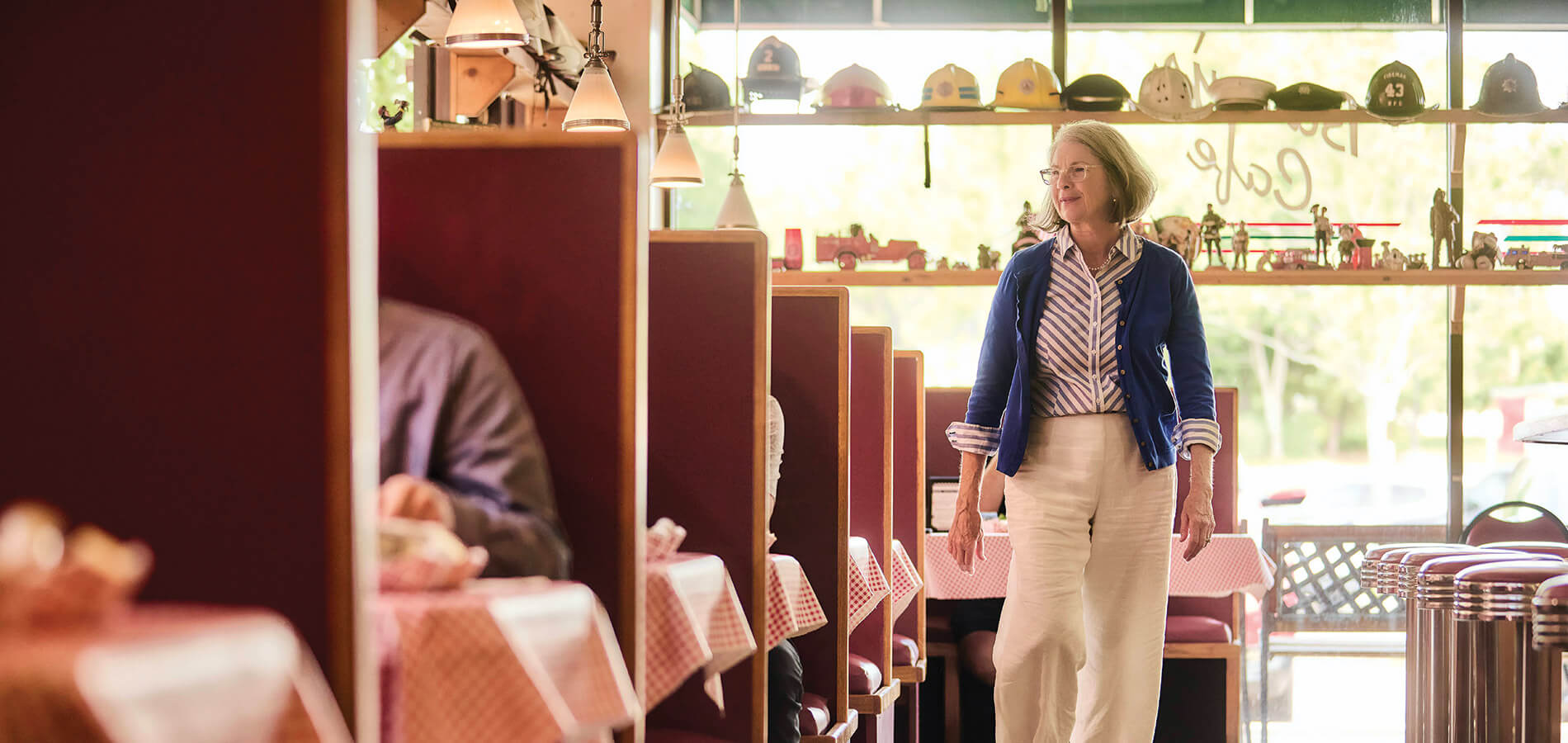 Denise Doyle strides between the booths at Barry's Cafe