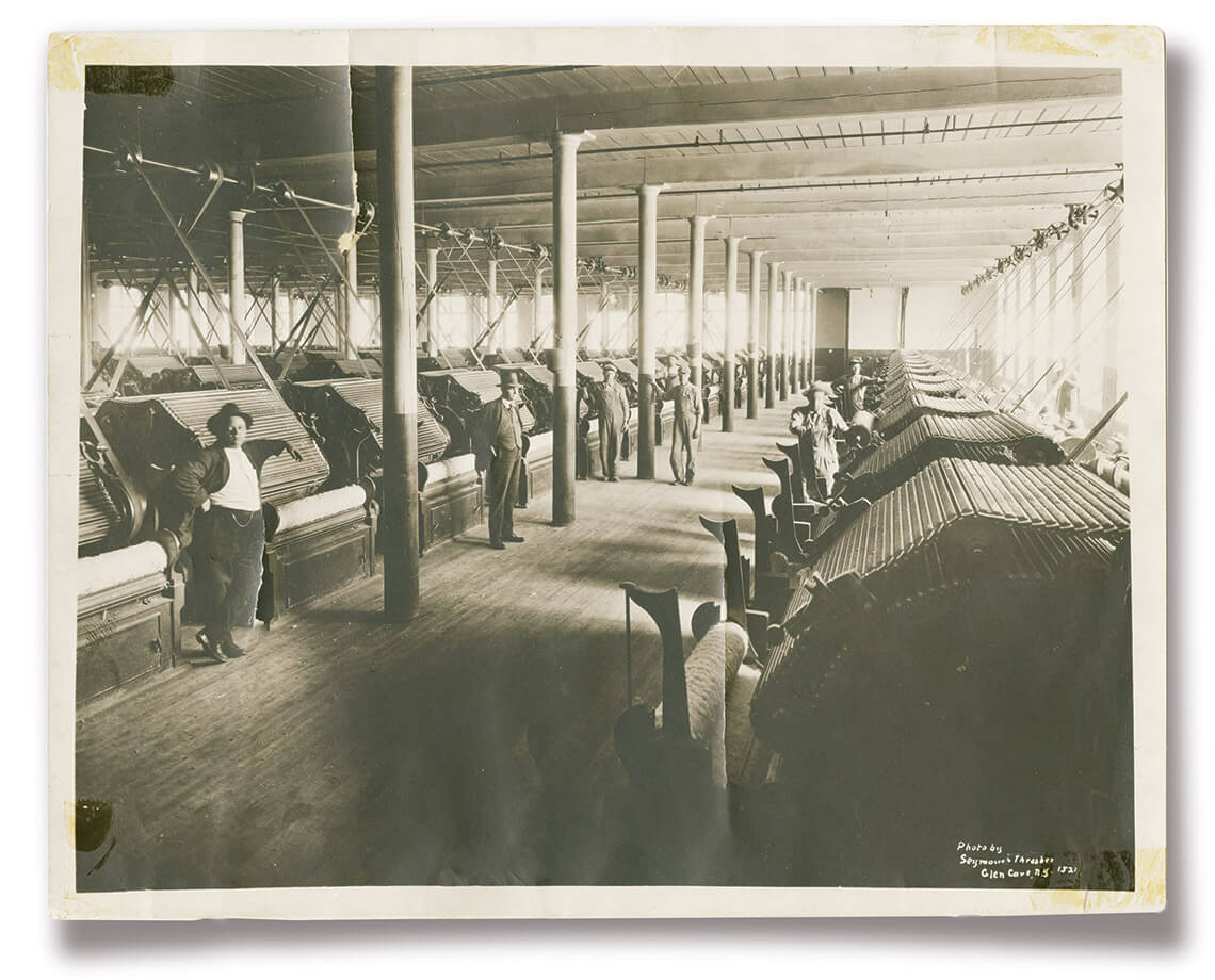 Black and white photo of people at a mill