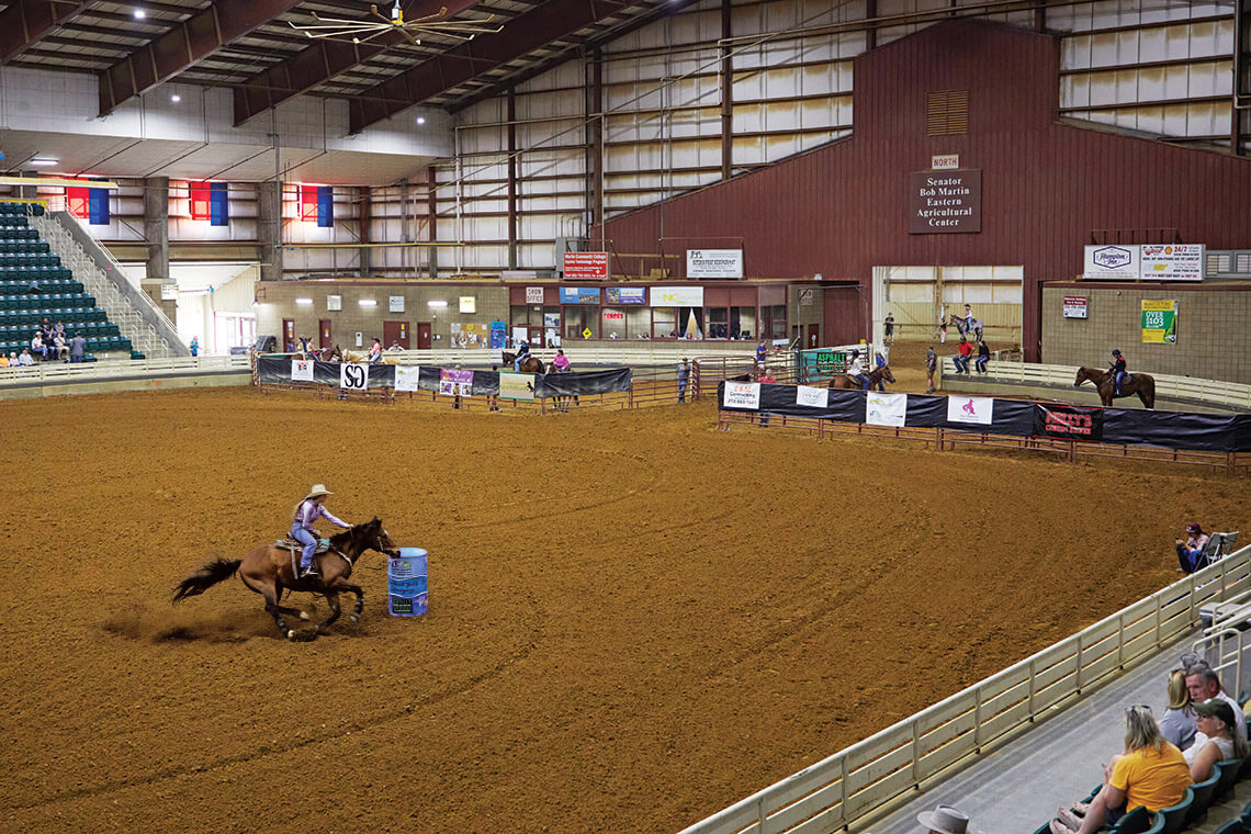 Young girl rides around the barrels at the Senator Bob Martin Agricultural Center