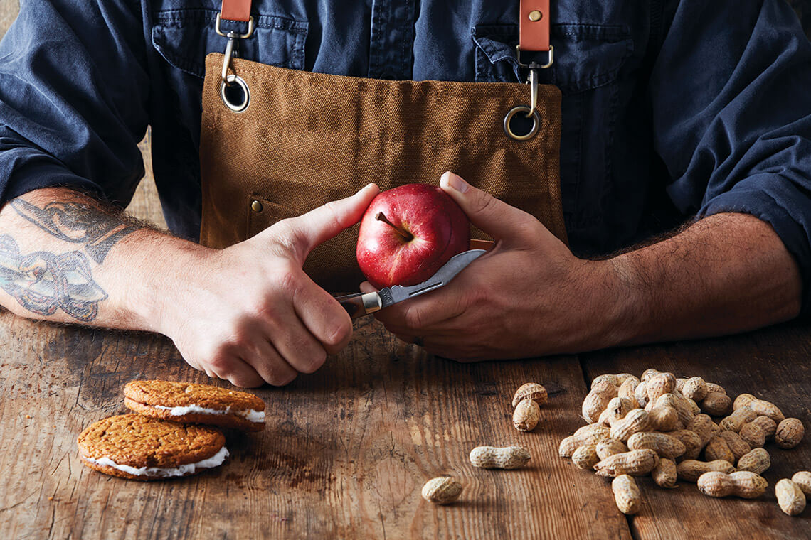 Man peeling an apple