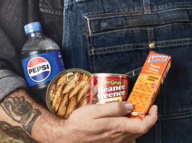 Man holding Pepsi, tinned fish, beanie weenies, and Nabs