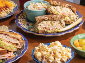 Table with assorted sandwiches and side of popcorn at Three Chopt Sandwich Shoppe in Hendersonville
