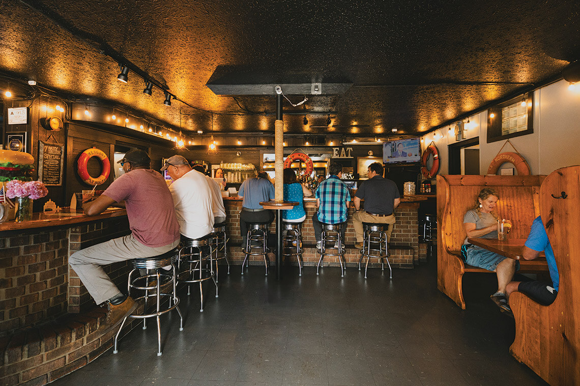 People sit at the bar in Winnie's Tavern
