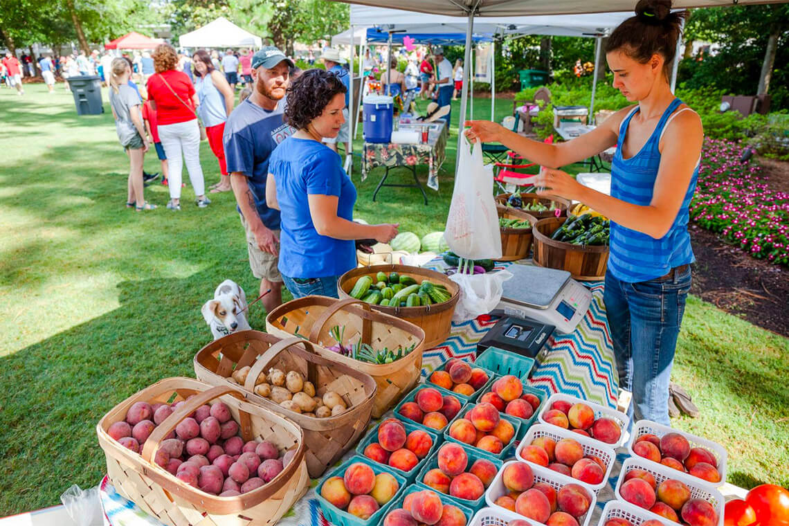 People shop for peaches at the Moore County Farmers Market
