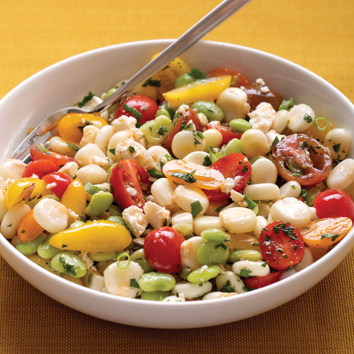 Bowl of solterito made with lima beans, corn, and tomatoes