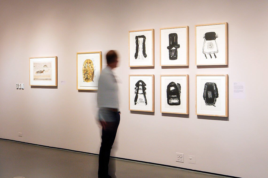 Visitor gazes at art at The Bechtler Museum of Modern Art