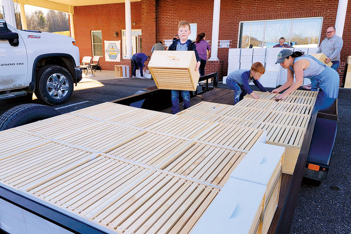 Volunteers assemble bee boxes after Helene