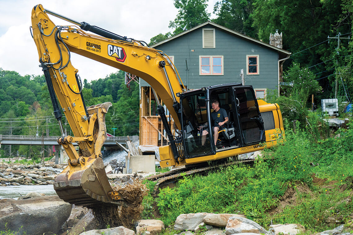 Jake Jarvis uses an excavator to help neighbors after Hurricane Helene