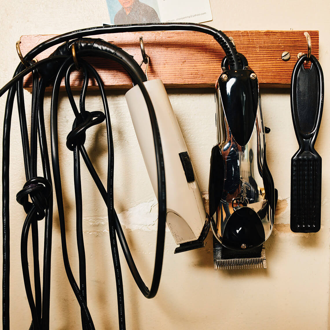 Hair trimmers and tools hanging on the wall of Sam & Bill's Hair Design