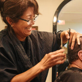 Mai McLean cutting to hair