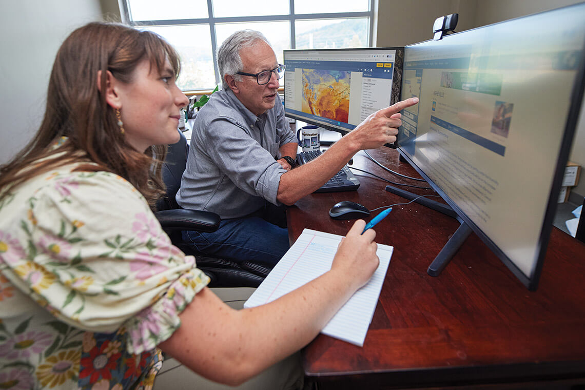 Maya Nelson and Ray Russell checking the forecast
