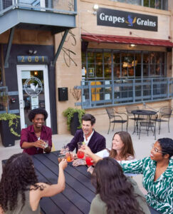 People gather outside of Grapes and Grains Tavern