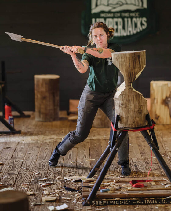 Dana Charles chopping a piece of wood at the Haywood Community College lumberjack school.