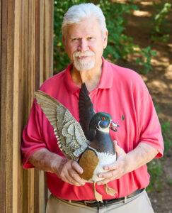 Nick Wehrmann holds a wooden duck decoy