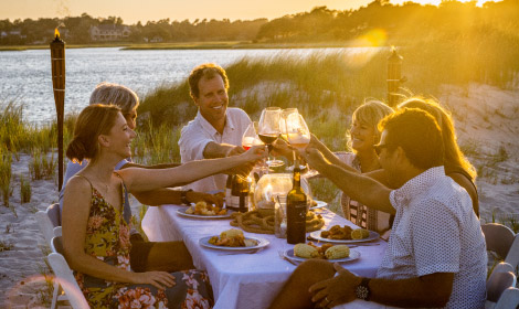 group having wine on the beach