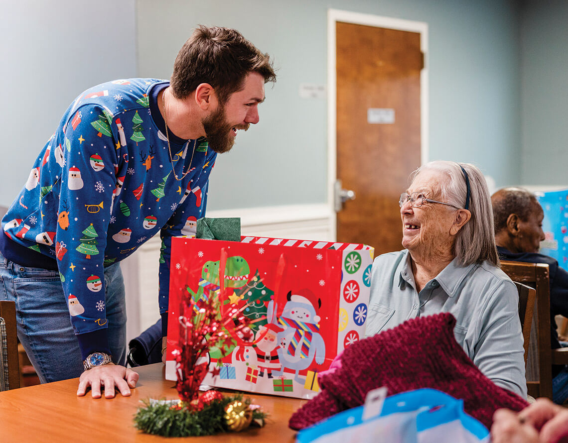 Nick greets Patricia Rowe with a Christmas present