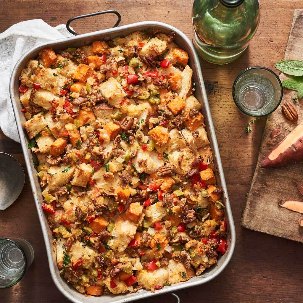 Casserole dish of sweet potato and pecan dressing