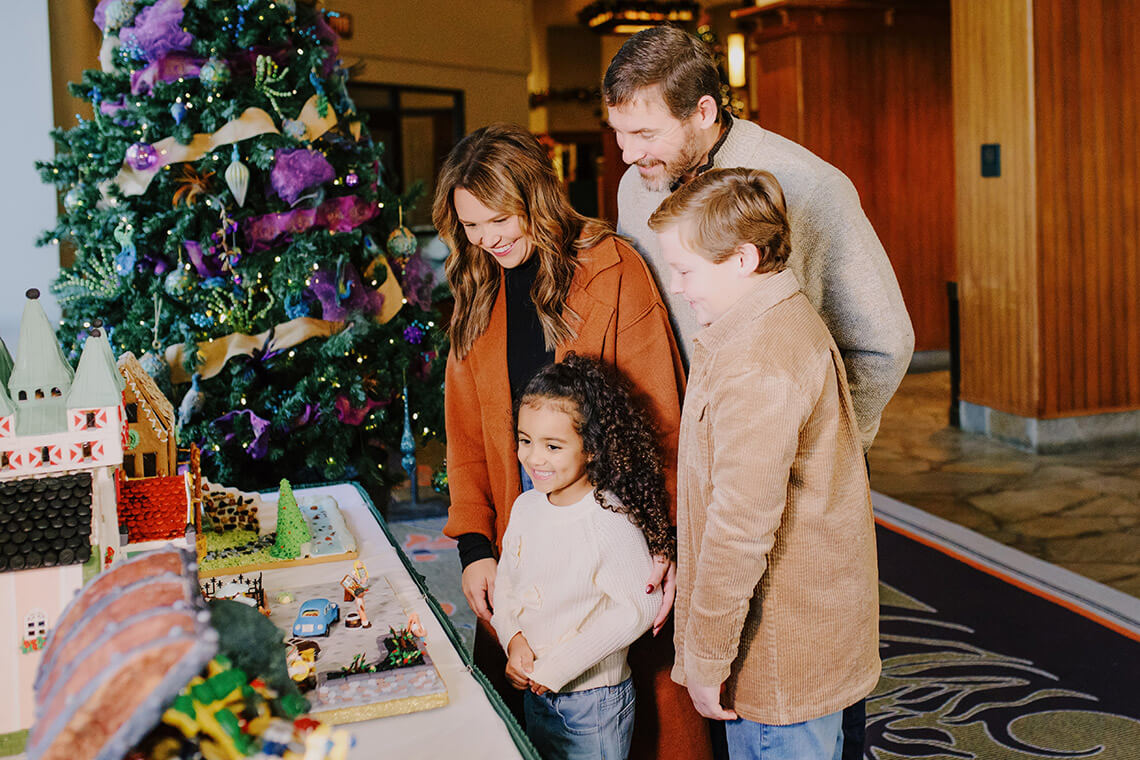 Family admire decorated gingerbread creations at Grove Park Inn