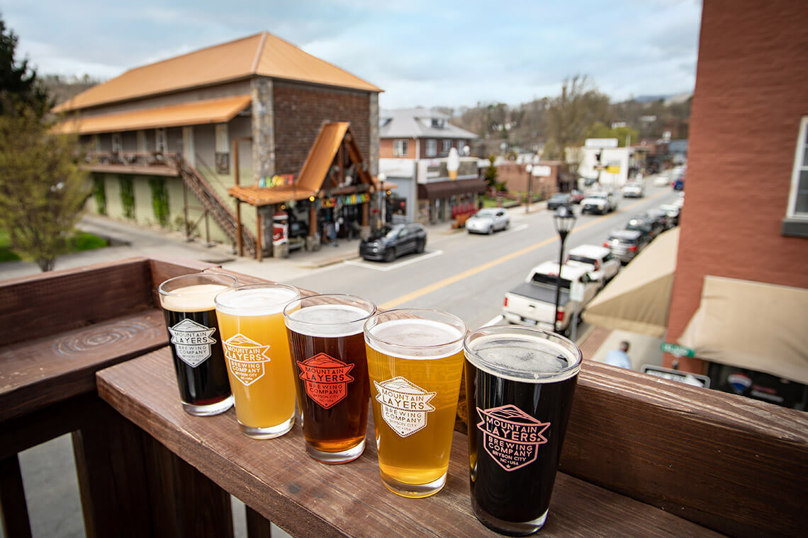 Beers on a rooftop deck at Mountain Layers Brewing Company