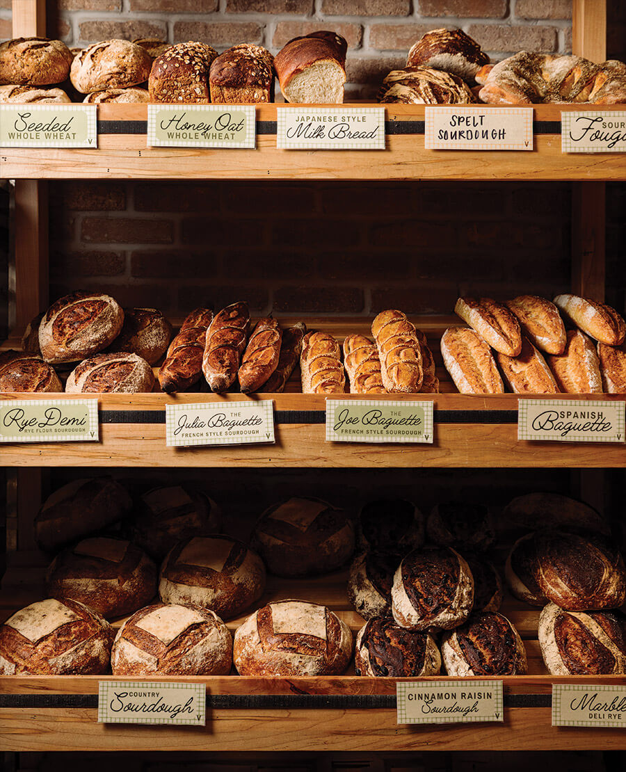 Shelves of sourdough and baguettes at Little Loaf Bakery and Schoolhouse
