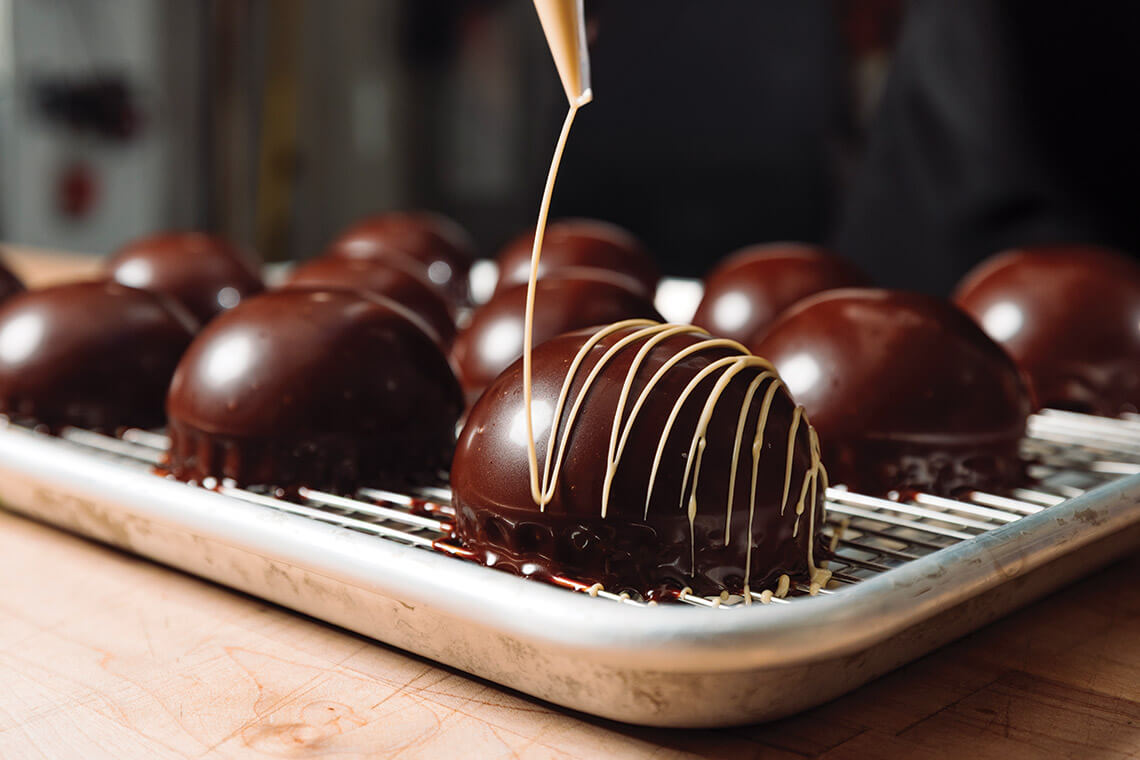 Icing chocolate cake bombes at Little Loaf Bakery
