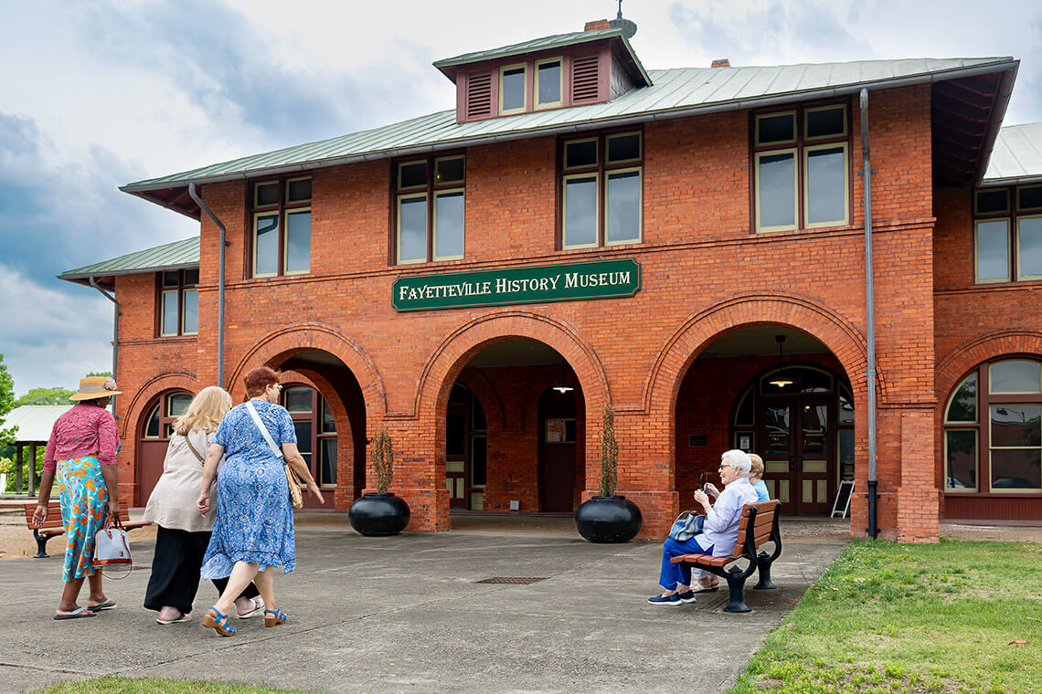 Exterior of the Fayetteville History Museum and visitors approaching