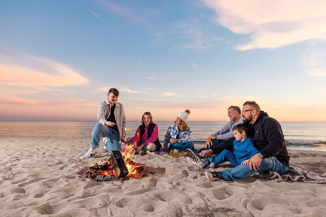 Family at a beach bonfire