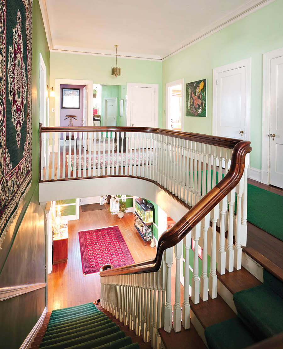 Green-carpeted staircase at Morehead Manor