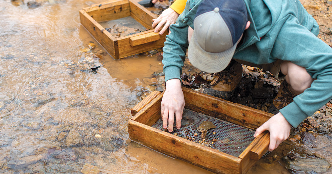 Person panning for precious rocks