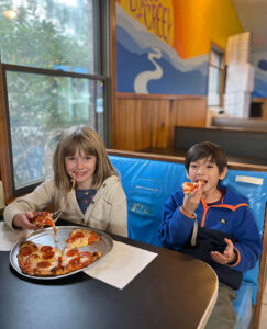Children eat pizza at Humble Pie