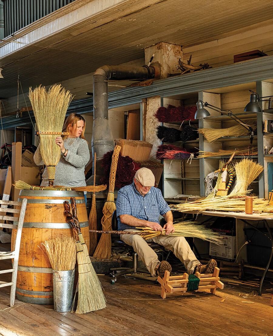 Marlow and Diana Gates making brooms