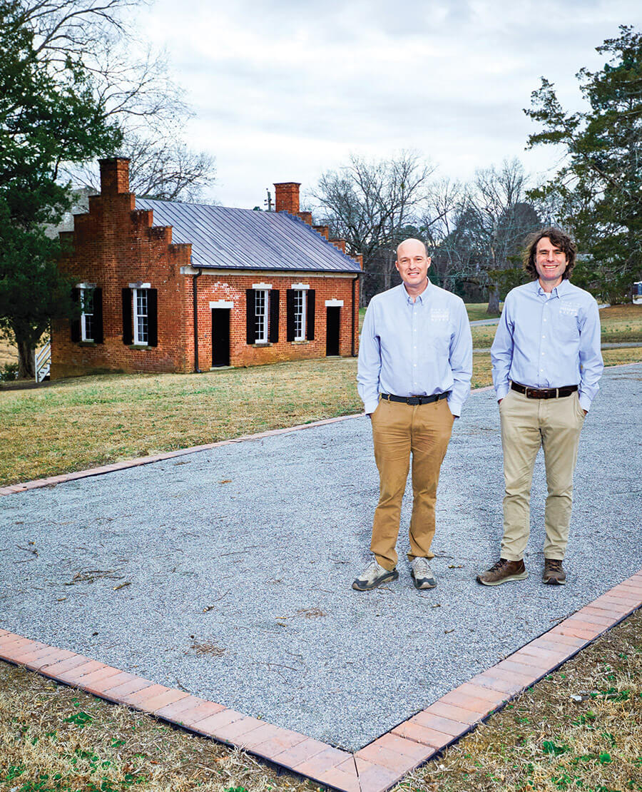 Burke and McMahon pose on the site of the colonial Halifax Courthouse.