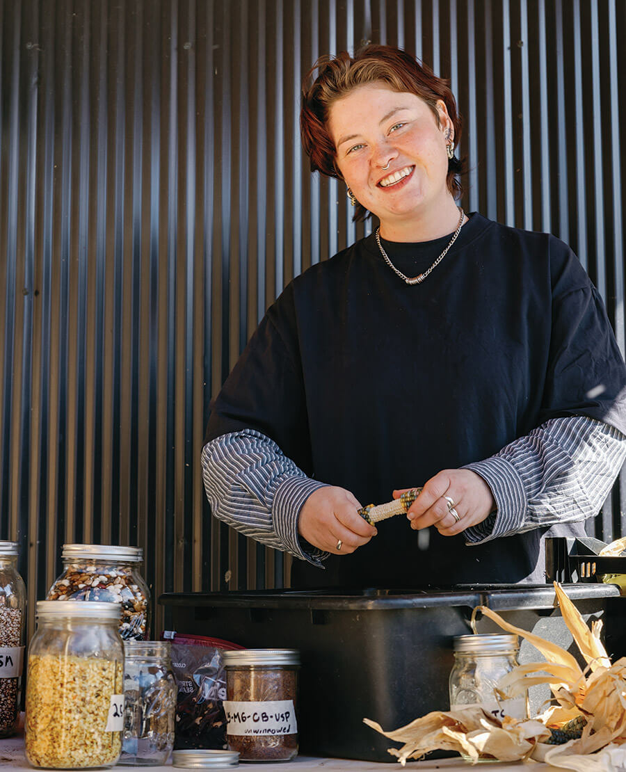 Leeza Chen collects seeds from heirloom corn